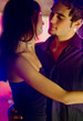 Young happy dancing amorous couple at celebration