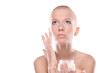 Foto: Woman is putting a cream on face Woman is putting a cream on face