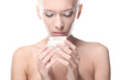 Foto: Woman is holding a cream in her hands Woman is holding a cream in her hands