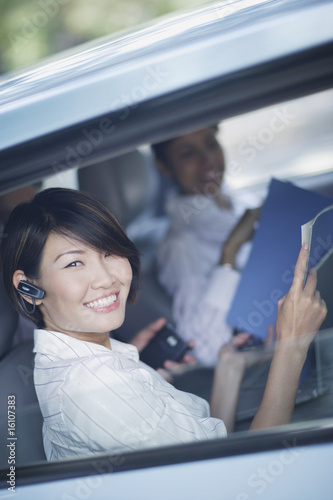 Photo: Three businesspeople in car with paperwork Three businesspeople in car with paperwork