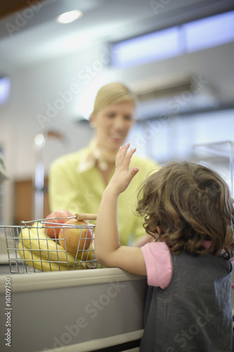 Photo: Young girl at grocery store check-out Young girl at grocery store check-out