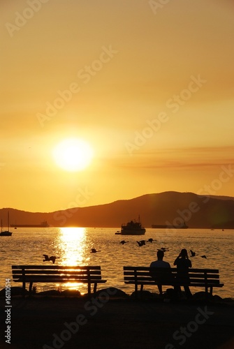 Silhouette of a couple enjoy beautiful sunset view