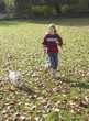 Young girl outdoors walking dog