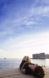 Foto: Croatia, Dubrovnik, woman lying on pier Croatia, Dubrovnik, woman lying on pier
