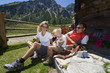 Austria, Salzburger Land, couple with daughter (6-7) taking a break