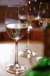 White wine bottle and glasses on wine cask, close-up