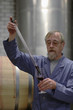 Man testing wine from cask