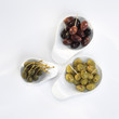 Olives and capers in bowls