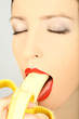 Young woman eating banana