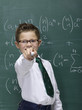 Boy (10-11) in front of blackboard, portrait, close-up