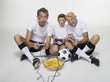 German soccer fans, playing video game, portrait