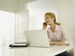 Young woman using mobile phone, smiling