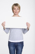 Young woman holding blank placard, portrait