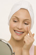Portrait of a young woman, drops of cream under her eyes
