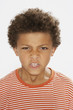 Young boy indoors looking mean