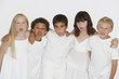 Five young children indoors sticking tongues out at camera