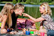 Young girl feeds her mother