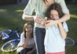 Two women helping an injured young girl who fell off her bike