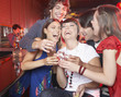 Five people with shots in nightclub toasting and smiling