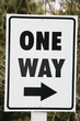 Close up of a one way sign.