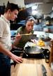 Young couple preparing lunch in kitchen