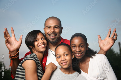 Happy African American family, father with teenage daughters.