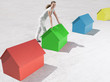 Woman standing with small model houses