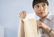 Businesswoman peaking at confidential documents