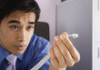 Photo: Businessman holding telephone connector plug Businessman holding telephone connector plug