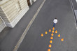 Man standing in front of traffic cones in arrow-shape