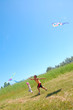 kids flying kites high up
