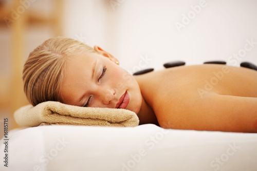Photo: Stone massage therapy: Cute woman relaxing at a spa Stone massage therapy: Cute woman relaxing at a spa