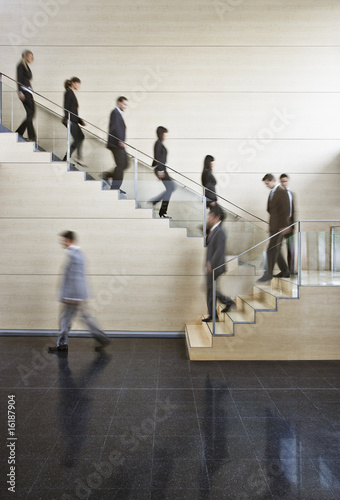 Photo: Businesspeople walking on office staircase Businesspeople walking on office staircase