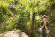Boys using walkie talkies in lush park