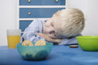 Boy sleeping on lunch table