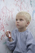 Boy scribbling on whiteboard