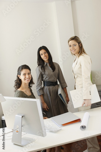 Photo: Businesswomen posing in office Businesswomen posing in office