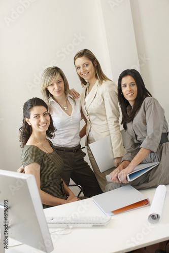 Photo: Businesswomen posing in office Businesswomen posing in office