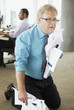 Frustrated businessman holding crumpled papers