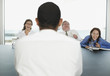 Businesspeople laughing during meeting in conference room
