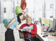 Businesswoman giving birthday gift to co-worker