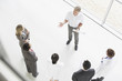 Businesspeople having meeting with blueprints