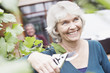 Senior woman holding gardening clippers