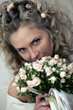 Bride smiling behind bouquet