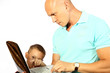 Foto: The boy shows to the daddy how to work on the computer The boy shows to the daddy how to work on the computer