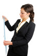Business woman looking at a measuring tape