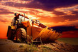 Yellow tractor on golden surise sky Yellow tractor on golden surise sky