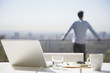 Man taking a break from working on balcony
