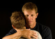 Photo: Father cries as he hugs his son Father cries as he hugs his son