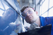 Technician inspecting car